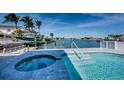 Enjoy outdoor living with a pool, spa, and waterfront view on the expansive patio at 629 59Th Ave, St Pete Beach, FL 33706