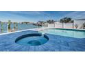Relax in the pool and spa overlooking the bay, with a manicured patio and privacy fence at 629 59Th Ave, St Pete Beach, FL 33706