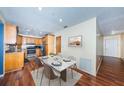 Charming eat-in kitchen features stainless appliances, warm oak cabinets, and modern marble-patterned dining table at 6445 109Th N Ave, Pinellas Park, FL 33782