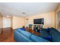 Spacious living room showcasing a comfortable sectional sofa, sleek wood floors, and a bright, airy ambiance for relaxation and enjoyment at 6445 109Th N Ave, Pinellas Park, FL 33782
