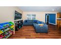 Inviting living room featuring a plush sectional sofa, warm wood floors, and natural light, creating a cozy and welcoming atmosphere at 6445 109Th N Ave, Pinellas Park, FL 33782