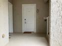 Inviting condo front door with a 'welcome' mat and visible unit number, creating a warm and secure entrance at 6815 Dali Ave # F101, Land O Lakes, FL 34637