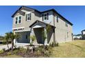 Two-story home with a two car garage, neat landscaping, and a brick paved driveway at 7105 119Th E Ct, Palmetto, FL 34221