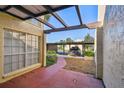 Carport view with a walkway to the front, showcasing covered parking and mature plants at 7200 Ulmerton Rd # B4, Largo, FL 33771