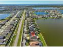 Wide aerial view of a residential neighborhood with several lakes and water features at 821 Seminole Sky Dr, Ruskin, FL 33570