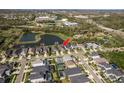 Beautiful community aerial view showcasing property's proximity to a pond and neighborhood amenities and highlighting the backyard at 9818 Stillchase St, Tampa, FL 33625