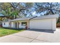 View of the house showing the driveway and the two car garage at 303 Suzette Dr, Brandon, FL 33511