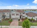 Lovely two-story home with brick driveway, two-car garage, and lush lawn in a lakeside community at 11544 Brighton Knoll Loop, Riverview, FL 33579