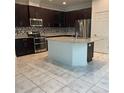 Beautiful kitchen with stainless steel appliances, granite countertops, tile flooring, and a large island at 11648 Palmetto Pine St, Riverview, FL 33569