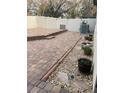Inviting backyard patio with pavers, rock garden, and privacy fence, perfect for outdoor entertaining at 11648 Palmetto Pine St, Riverview, FL 33569