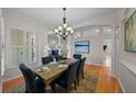 Bright dining room boasts wood floors, blue chairs, decor lighting, and shutters at 11815 Marblehead Dr, Tampa, FL 33626