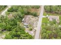 Aerial view of a house nestled among lush greenery and neighboring homes, showcasing its peaceful setting at 12651 Tinley Rd, New Port Richey, FL 34654