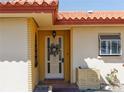 Welcoming front entrance featuring decorated front door, sidelight, brick accents and attractive welcome mat at 1450 Highfield Dr, Clearwater, FL 33764