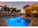 Sparkling pool with a screened-in lanai, canal views, and lounge seating at 1472 47Th Ne Ave, St Petersburg, FL 33703