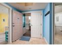 Condo entryway featuring blue accent walls, tiled flooring, and a hallway leading to other rooms at 1520 Gulf Blvd # 805, Clearwater Beach, FL 33767