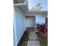 View of the front door and walkway leading to the entrance, with brick-lined walk at 1982 Seton Dr, Clearwater, FL 33763