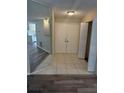 Foyer featuring tile flooring, a mirrored wall, and a view into the kitchen and living spaces at 1982 Seton Dr, Clearwater, FL 33763