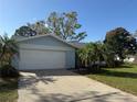 The home has an attached two-car garage, mature landscaping, and a well-maintained yard at 1982 Seton Dr, Clearwater, FL 33763