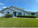 Beautiful single-Gathering home with blue shutters and a well-manicured lawn at 284 Hemingway Dr, Oldsmar, FL 34677