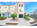 Charming three-story townhome with a private garage and landscaped front yard at 4405 Tuscan Loon Dr, Tampa, FL 33619