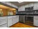 Well-lit kitchen with stainless steel appliances, black countertops, and distressed white cabinets at 5203 Bayshore Blvd # 5, Tampa, FL 33611