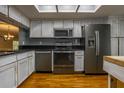 Well-lit kitchen with stainless steel appliances, black countertops, and distressed white cabinets at 5203 Bayshore Blvd # 5, Tampa, FL 33611