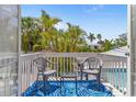 Outdoor balcony area with seating, ideal for relaxation with a view of tropical plants at 8517 43Rd W Ave, Bradenton, FL 34209