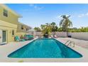 Backyard swimming pool with lounge chairs and tropical landscaping, perfect for outdoor living at 8517 43Rd W Ave, Bradenton, FL 34209