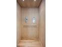 Interior view of a residential elevator with wooden paneling and simple controls at 870 N Osceola Ave, Clearwater, FL 33755
