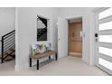 Elegant entryway with an elevator, a modern staircase, and a stylish bench at 870 N Osceola Ave, Clearwater, FL 33755