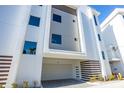 Modern three-story condo exterior featuring a private garage and decorative accents at 870 N Osceola Ave, Clearwater, FL 33755