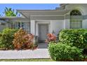 Inviting front entrance with colorful landscaping and a classic doorway at 915 Brittany Park Blvd, Tarpon Springs, FL 34689