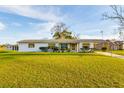 Charming one story home with white exterior, awnings, and large front yard at 9170 Dupont Ave, Spring Hill, FL 34608