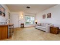 Cozy living room featuring a neutral sofa, desk, and plenty of natural light at 9170 Dupont Ave, Spring Hill, FL 34608