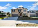 Charming two-story home with a neatly kept lawn, featuring a two-car garage and inviting curb appeal at 9505 Lemon Drop Loop, Ruskin, FL 33573