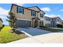 Attractive two-story home with a spacious two-car garage, highlighted by its clean landscaping and pleasant facade at 9505 Lemon Drop Loop, Ruskin, FL 33573
