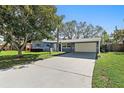 Inviting single-story home with a spacious driveway, attached carport, and well-maintained front yard at 9862 48Th N Ave, St Petersburg, FL 33708