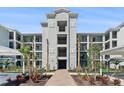 Stylish four-story condo building entrance featuring well-manicured landscaping and convenient accessibility at 14191 Heritage Landing Boulevard # 1234, Punta Gorda, FL 33955