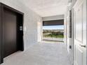 Condo hallway with elevator and balcony showcasing neighborhood views at 14191 Heritage Landing Boulevard # 1234, Punta Gorda, FL 33955