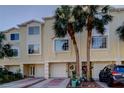 Charming townhome featuring a well-maintained exterior with lush landscaping and an attached garage at 152 Brent Cir, Oldsmar, FL 34677