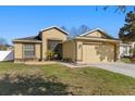 Inviting single Gathering home with lush green lawn, a two-car garage, and quaint front porch at 18130 Arbor Crest Dr, Hudson, FL 34667