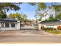 Gated community entrance featuring the name 'Crowder Manor' surrounded by beautiful trees and landscaping at 2515 S Ysabella Ave, Tampa, FL 33629