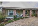 Inviting front porch with brick columns and a decorative sun art piece at 3111 Teal Ter, Safety Harbor, FL 34695