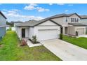 Inviting single-story home featuring a concrete driveway and manicured front yard at 35530 Shade Fern Ln, Zephyrhills, FL 33541