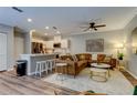 Open-concept living room with modern furnishings, including a leather couch, and access to the kitchen at 402 S Willow Ave # D, Tampa, FL 33606