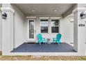 Inviting front porch features stylish columns, outdoor lighting, and comfortable seating at 4104 E Comanche Ave, Tampa, FL 33610