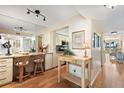 Cozy kitchenette with a breakfast bar, granite countertops, hardwood floors, and ample natural light at 6021 Bahia Del Mar Cir # 234, St Petersburg, FL 33715