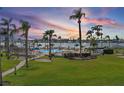 A luxurious community pool area with lush tropical landscaping, waterfront views, and ample seating under palm trees at 6021 Bahia Del Mar Cir # 234, St Petersburg, FL 33715