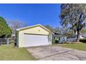 The image focuses on the two car garage and the well-maintained exterior of the house at 808 Smith Bay Dr, Brandon, FL 33510