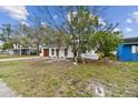 Charming single story home with a new gray roof, red door, and a well-maintained front yard at 8930 94Th Ave, Seminole, FL 33777